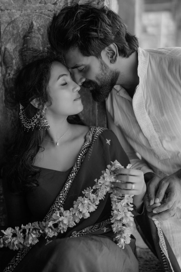 A couple sharing a tender moment, embracing love and culture in traditional attire.